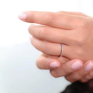 Refined round half eternity moissanite wedding band angled view showing its sparkle