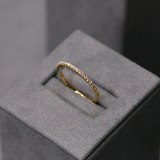 Vintage round half eternity moissanite wedding band close up of the setting