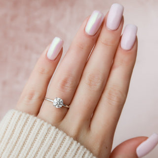 Modern 1.0ct round hidden halo moissanite ring angled view showing its sparkle