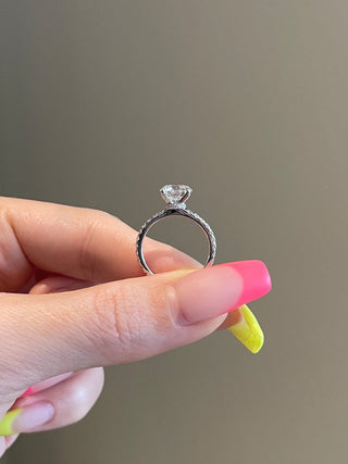 Lustrous 2.0ct round hidden halo moissanite ring angled view showing its sparkle