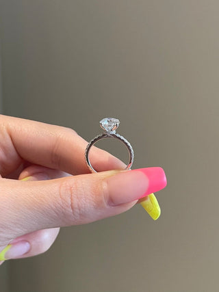 Lustrous 2.0ct round hidden halo moissanite ring side profile view