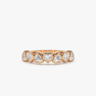 Sparkling heart bezel moissanite wedding band shown on a finger