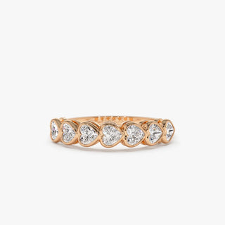 Dazzling heart bezel moissanite wedding band shown on a finger