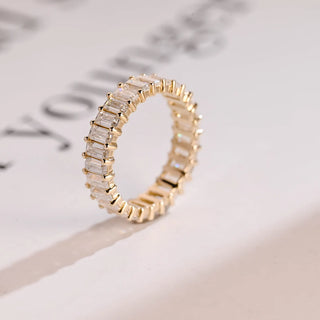Luminous emerald full eternity moissanite wedding band close up of the setting