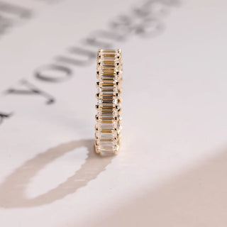 Luminous emerald full eternity moissanite wedding band angled view showing its sparkle