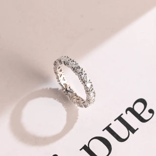 Graceful heart full eternity moissanite wedding band shown on a finger