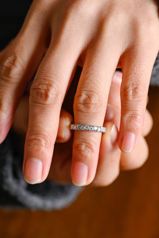 Graceful heart full eternity moissanite wedding band three quarter angled view