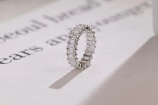 Delicate emerald full eternity moissanite wedding band close up of the setting