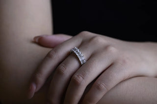 Delicate emerald full eternity moissanite wedding band three quarter angled view