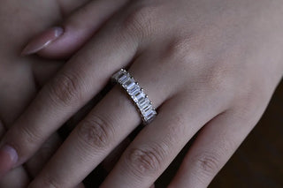 Delicate emerald full eternity moissanite wedding band detail view of the band