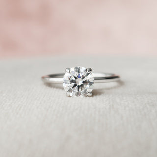Modern 1.0ct round hidden halo moissanite ring shown on a finger