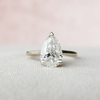 Refined 2.0ct pear hidden halo moissanite ring three quarter angled view