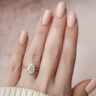 Sparkling 2.0ct pear hidden halo moissanite ring side profile view