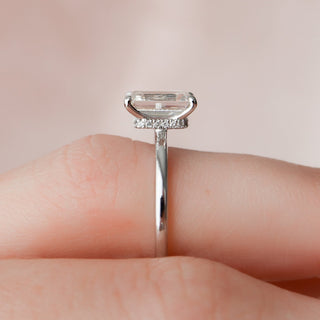 Gorgeous 2.0ct emerald hidden halo moissanite ring shown on a finger
