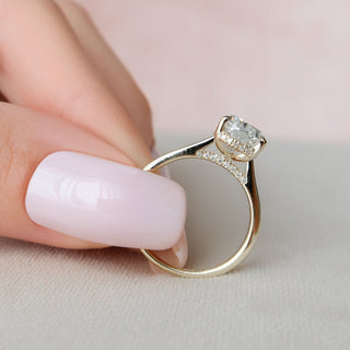 Brilliant 2.0ct pear hidden halo moissanite ring shown on a finger