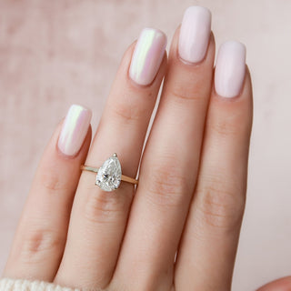 Brilliant 2.0ct pear hidden halo moissanite ring angled view showing its sparkle