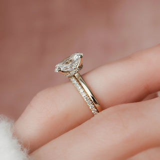 Brilliant 1.50ct oval hidden halo moissanite wedding band shown on a finger