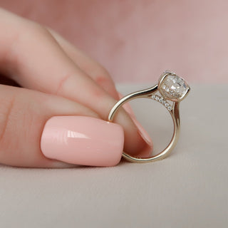 Delicate 3.0ct oval hidden halo moissanite ring shown on a finger