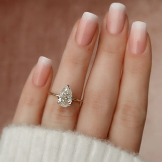 Sparkling 2.0ct pear hidden halo moissanite ring angled view showing its sparkle