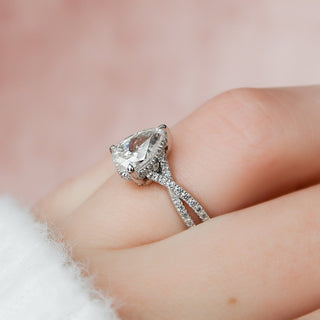 Shimmering 1.0ct pear hidden halo moissanite ring shown on a finger