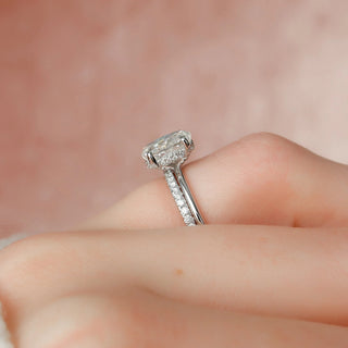 Timeless 1.5ct oval hidden halo moissanite wedding band shown on a finger