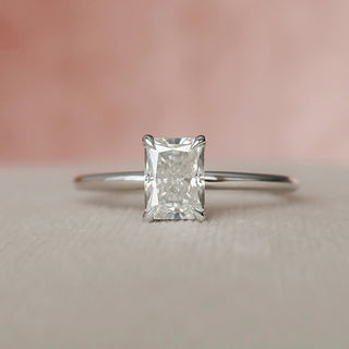 Sparkling 1.0ct radiant hidden halo moissanite wedding band shown on a finger