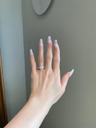 Sparkling 2.0ct round hidden halo moissanite ring shown on a finger