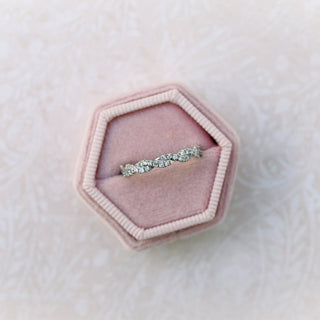 Exquisite round full eternity moissanite wedding band shown on a finger image 2
