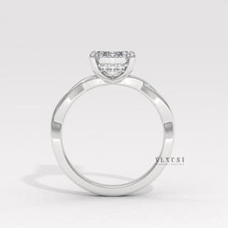 Macro shot of the centre stone on a emerald cut moissanite engagement ring on an infinity band