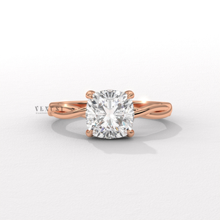 Studio shot of a cushion cut moissanite engagement ring on an infinity band on a plain backdrop