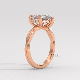 Top-down view of a pear cut moissanite engagement ring on an infinity band
