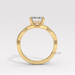 Close-up of a emerald cut moissanite engagement ring on an infinity band