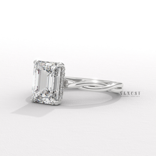 Full view of a emerald cut moissanite engagement ring on an infinity band with band detail