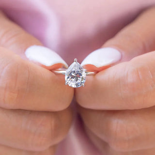 Bold 1.33ct pear hidden halo moissanite ring front view