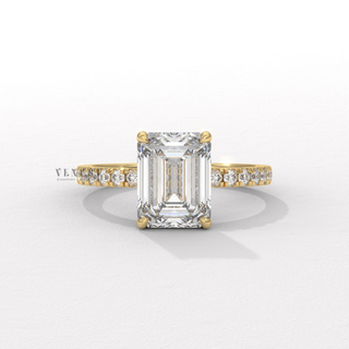 Front view of a emerald cut moissanite engagement ring with a hidden halo and pave band
