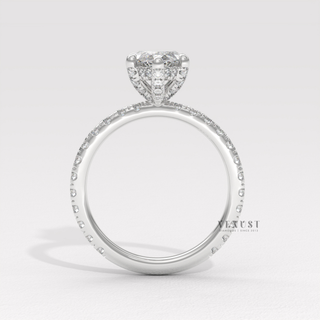 Marquise cut moissanite engagement ring with a hidden halo and pave band shown on a finger