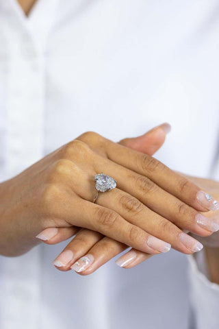 Elongated oval three stone moissanite engagement ring angled sparkle view