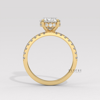 Front view of a oval cut moissanite engagement ring with a hidden halo and half pave band from the right