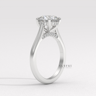 Front view of a round brilliant moissanite engagement ring with a hidden halo and cathedral setting