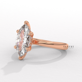 Tilted view of a marquise cut moissanite engagement ring in a hidden halo solitaire setting showing its sparkle