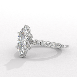 Close-up of a marquise cut moissanite engagement ring with a hidden halo and pave band