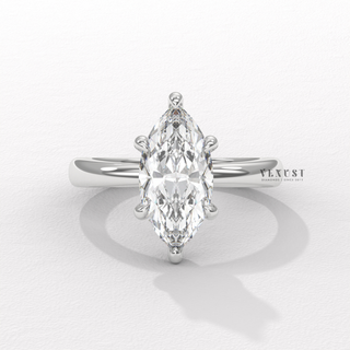 Marquise cut moissanite engagement ring in a hidden halo solitaire setting photographed on a white background