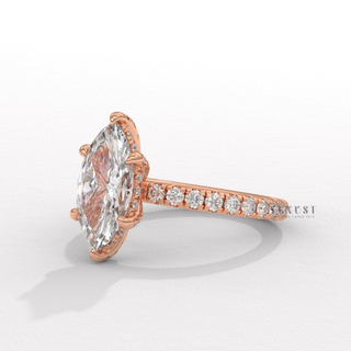 Top-down view of a marquise cut moissanite engagement ring with a hidden halo and pave band
