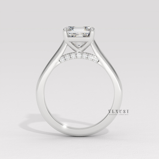 Profile shot of a asscher cut moissanite engagement ring with a hidden halo and cathedral setting and its band