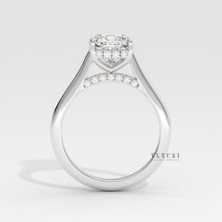 Top-down view of a cushion cut moissanite engagement ring with a hidden halo and cathedral setting