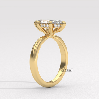 Hand model wearing a marquise cut moissanite engagement ring in a hidden halo solitaire setting