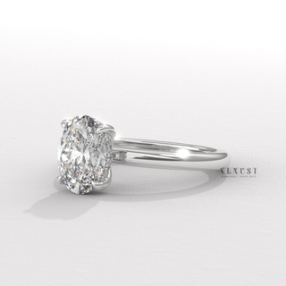 Front view of a oval cut moissanite engagement ring in a hidden halo solitaire setting with the stone in focus