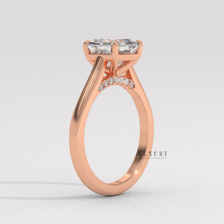 Studio shot of a asscher cut moissanite engagement ring with a hidden halo and cathedral setting on a plain backdrop