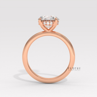 Studio shot of a round cut moissanite engagement ring in a solitaire setting on a plain backdrop