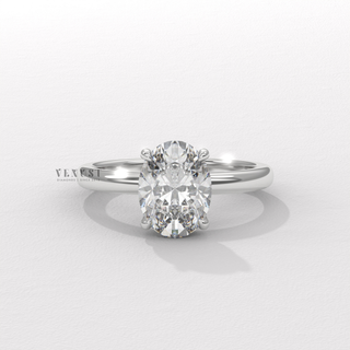 Front view of a oval cut moissanite engagement ring in a hidden halo solitaire setting from a high angle